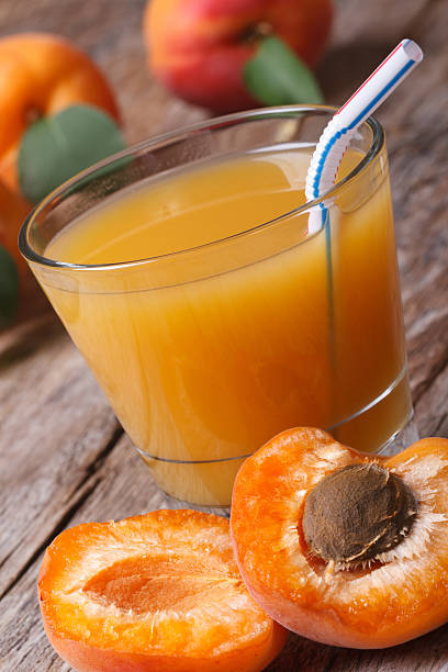 istock Apricot nectar with fruit halves closeup vertical 504561883