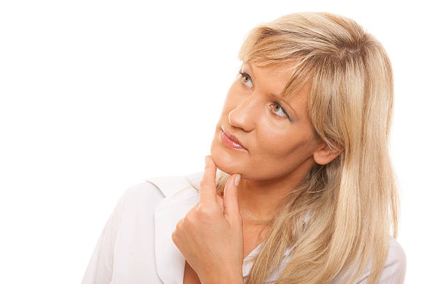 istock Thinking mature woman looking up isolated 504561923