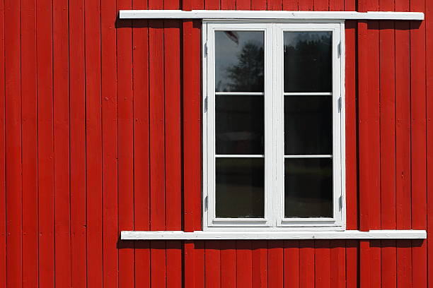 istock Small window in a red wooden house 504566045