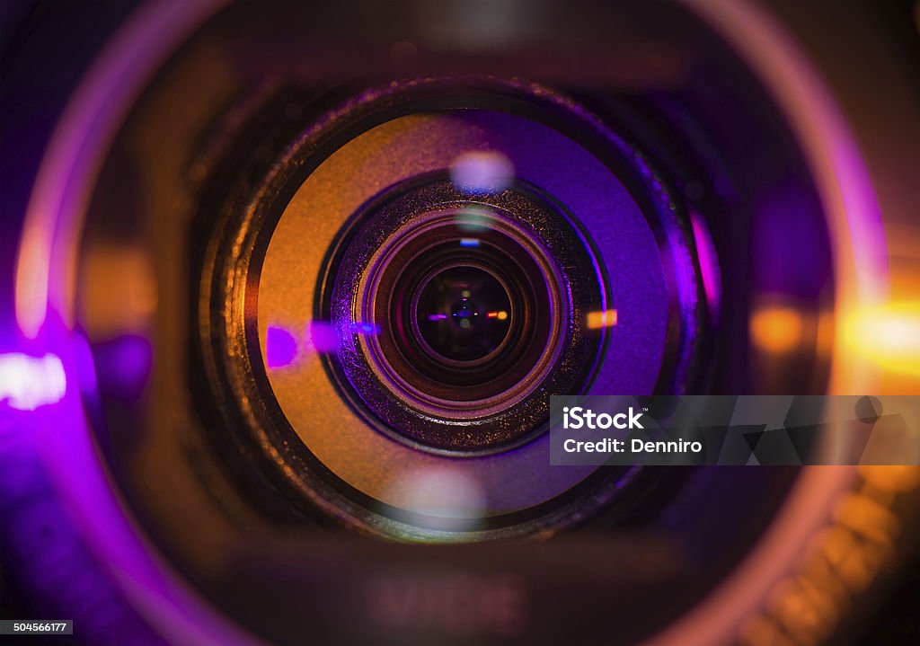 Video camera lens Video camera lens lit in orange and purple Video Production Stock Photo