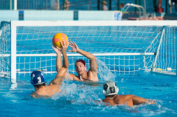 Water Polo Scoring Action Shot of young water polo players having goal action water polo stock pictures, royalty-free photos & images