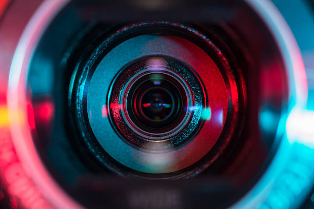 Video camera lens Video camera lens lit in red and blue filming stock pictures, royalty-free photos & images