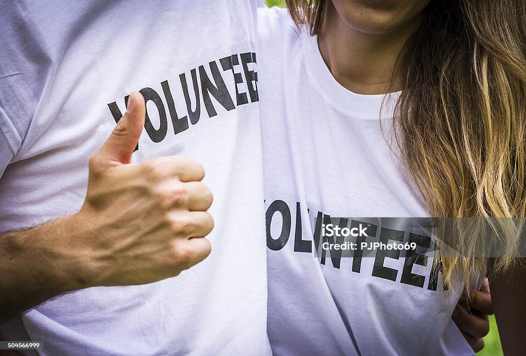 Couple of volunteers with thumbs up Couple of volunteers with thumbs up - Close up on hand 20-29 Years Stock Photo