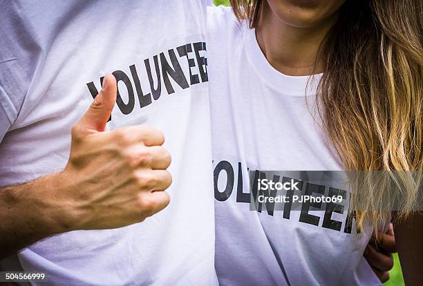 Couple Of Volunteers With Thumbs Up Stock Photo - Download Image Now - 20-29 Years, Adolescence, Adult