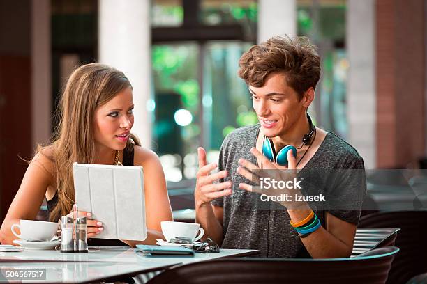 Young Couple In Cafe Stock Photo - Download Image Now - Adolescence, Cafe, Discussion