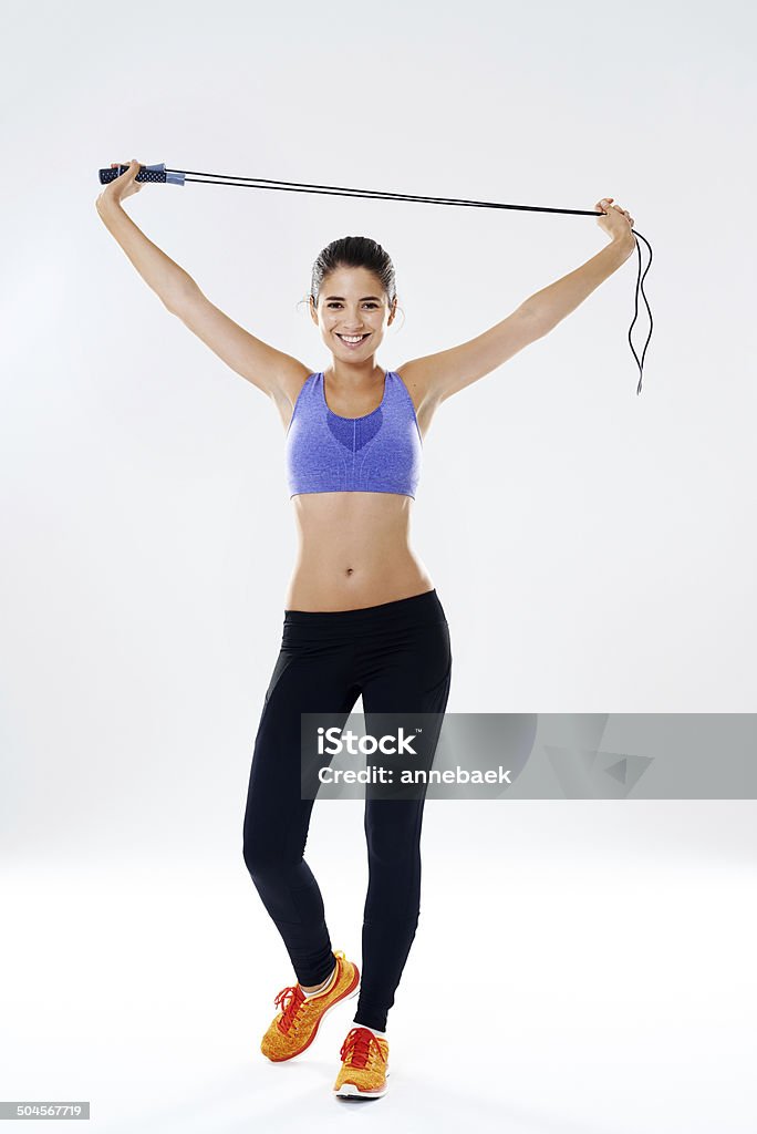 Let's get that heart rate going Portrait of an attractive young woman holding a jump rope above her head 30-39 Years Stock Photo
