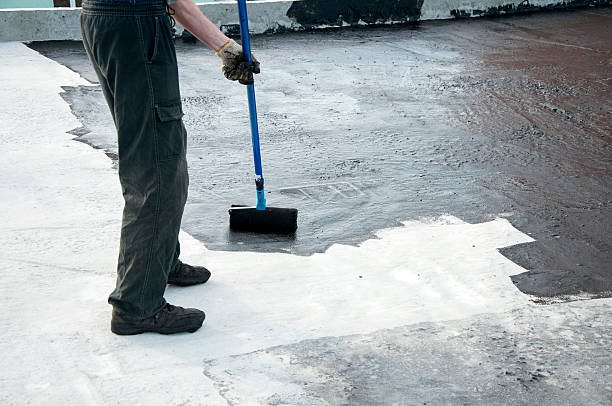 istock Roofer worker painting   roller brush,   waterproofing 504572406