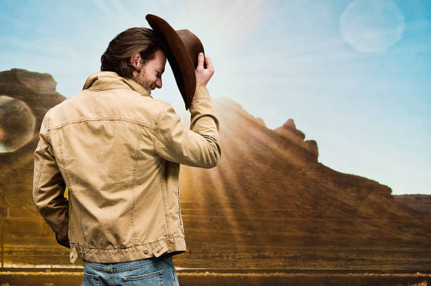istock Cowboy standing in front of hill 504573478