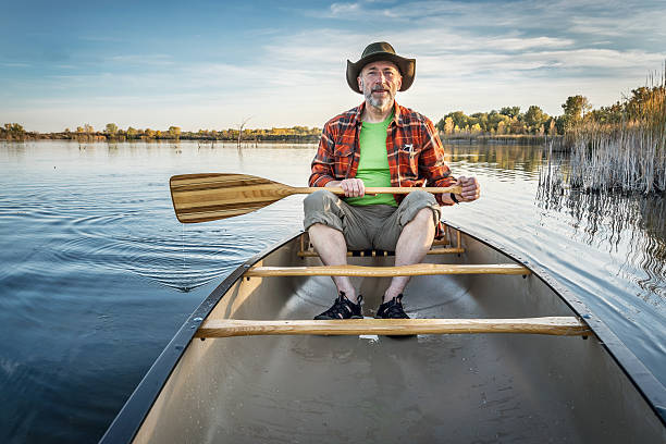 istock canoeing on a calm lake in fall 504574650