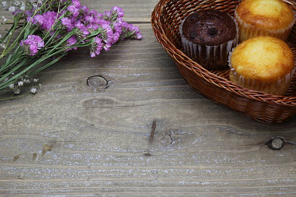Still with muffin and flower, selective focus on flower
