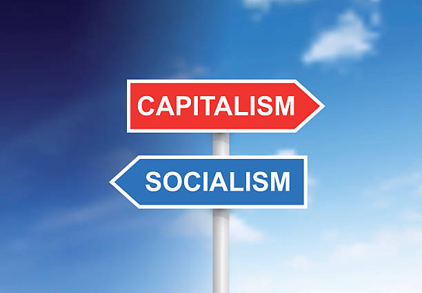 objawy "capitalism” i" socjalizm "na niebie - socialism stock illustrations