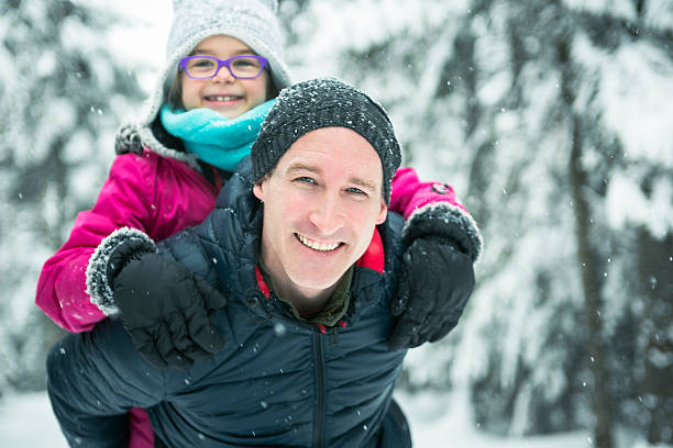 istock Father and daughter enjoying snow at daytime 504577236