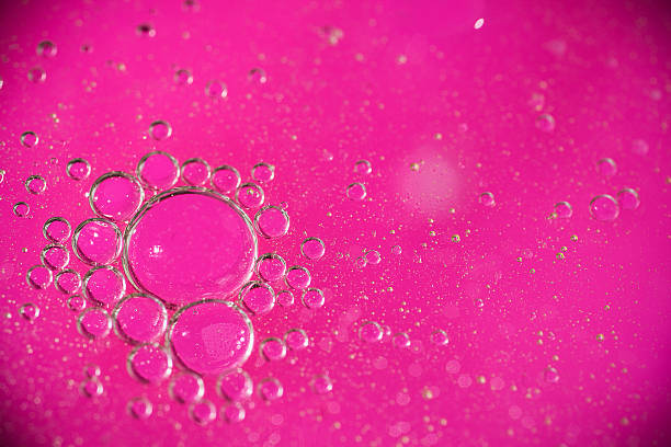 istock Bubbles in oil with a pink background 504579778