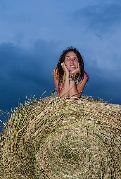 istock Girl jumping on a hay field 504579803
