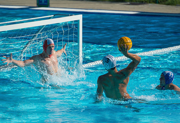 Water Polo Attractive Goal Action Side view of water polo players having goal action water polo photos stock pictures, royalty-free photos & images
