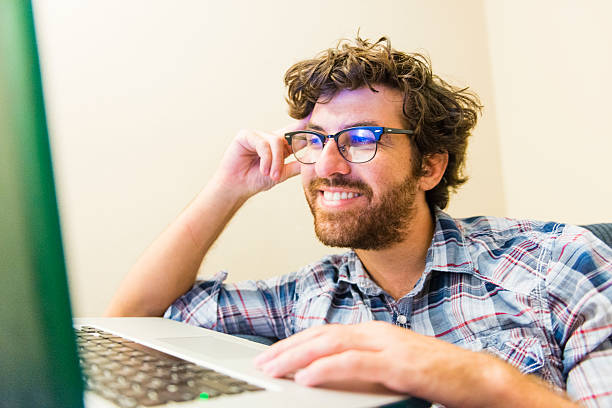 istock Online American Man Smiles at Social Media Networking 504581046