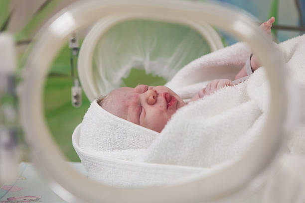 istock Tiny baby girl in her cot just after birth 504581839