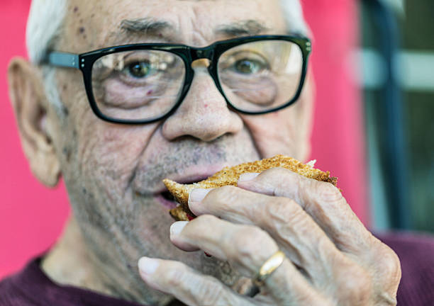 istock Senior Man Eating Toasted Sandwich 504581983