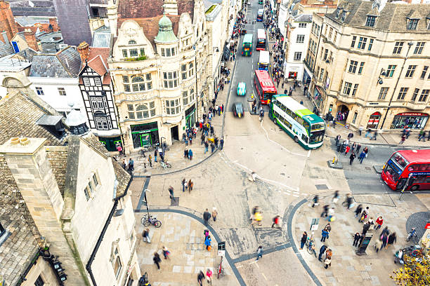Oxford City View Oxford City, one of the most popular cities with universities in UK. Aerial view on the city crossroad - houses, people and busses. oxford england stock pictures, royalty-free photos & images