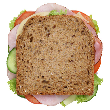 Sandwich toast bread for breakfast with ham, cheese, tomatoes, lettuce top view isolated on a white background