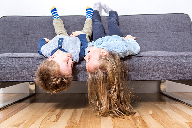 istock two nice child boy and girl on sofa 504583896