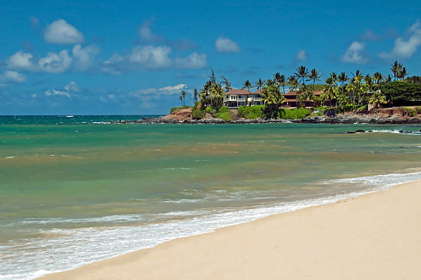 waves, sand and blue sky at 'Ehukai Beach Park in Oahu Hawaii