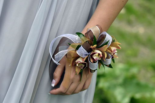 A close-up of a corsage on a girl's wrist.