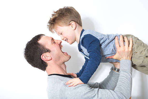 istock happy father and son play in front of a white 504584536