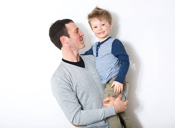 istock happy father and son play in front of a white 504584576