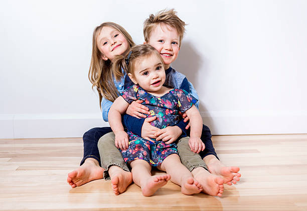 istock three child sit on the floor at home 504584786