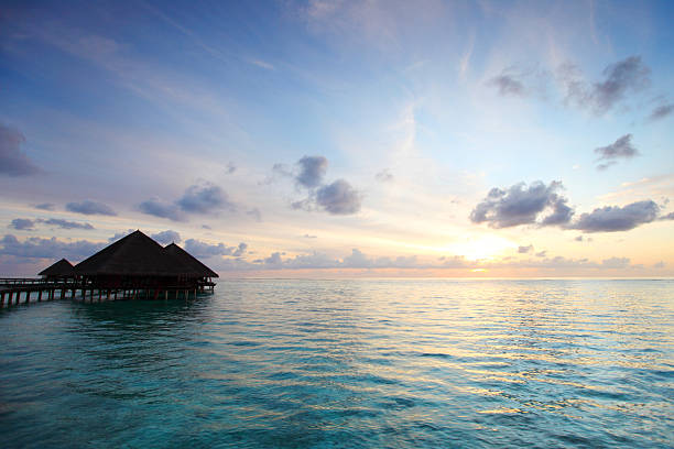 istock maldivian houses on sunrise 504585123