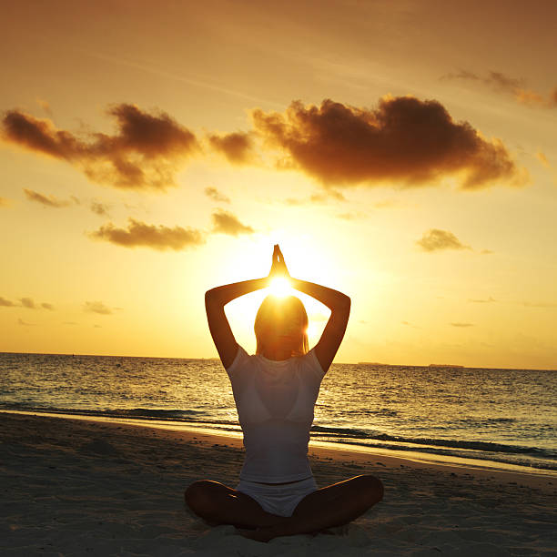istock sunset yoga woman 504585737