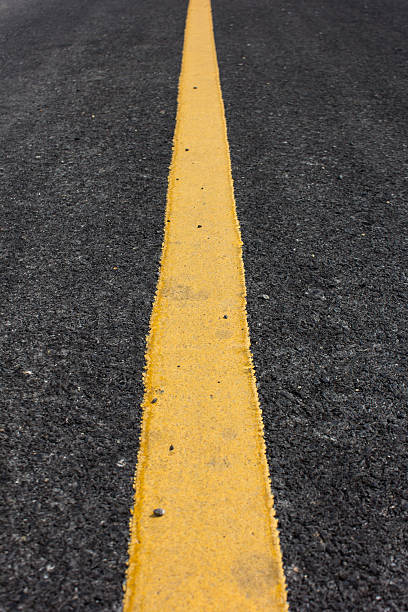 istock Close up road divide yellow line 504586217