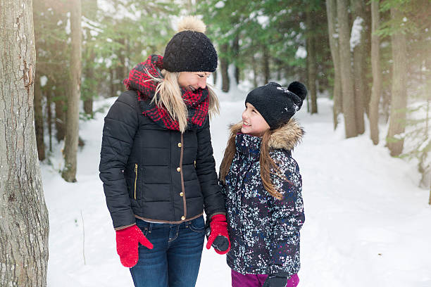 istock Mother and daughter having fun in the winter park 504586556