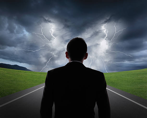 istock business man look rainstorm clouds and lightning 504586927