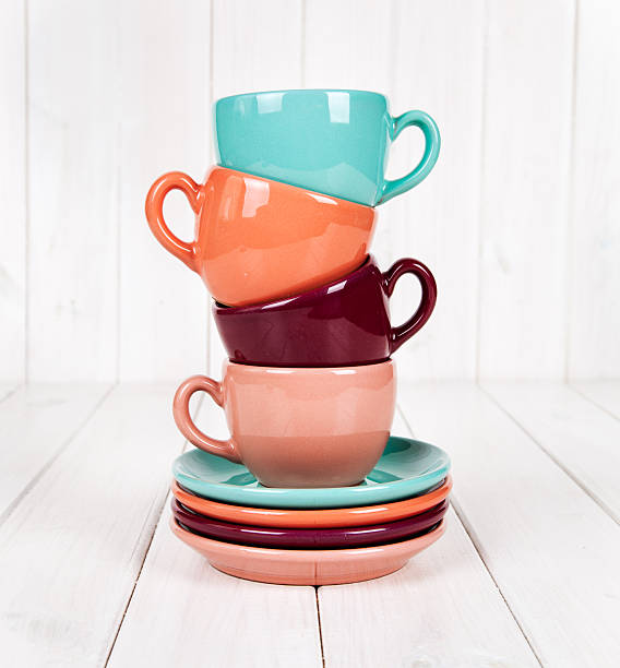 istock Colorful coffee cups on white wooden background 504587136
