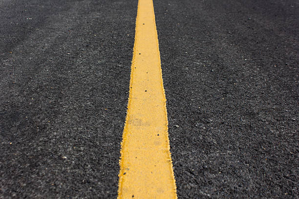 istock Close up road divide yellow line 504587333