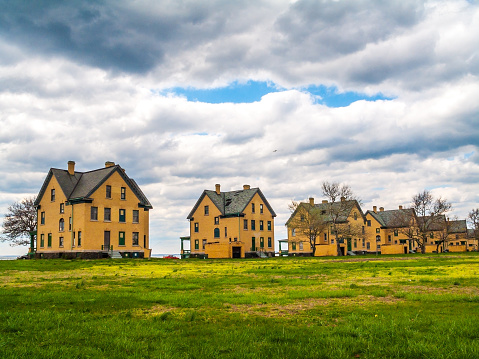 An open field with the historic Fort Hancock homes on Sandy Hook in New Jersey.