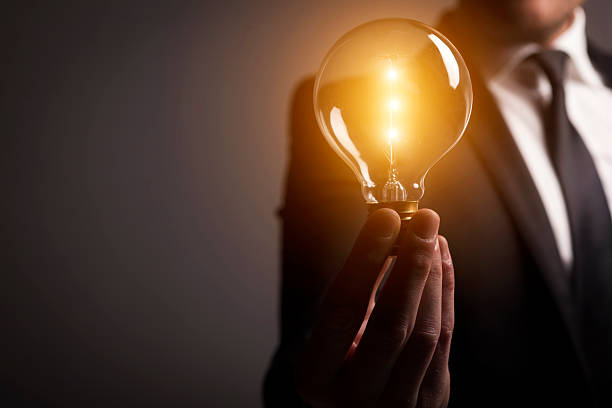 new idea - light bulb businessman inspiration ideas foto e immagini stock