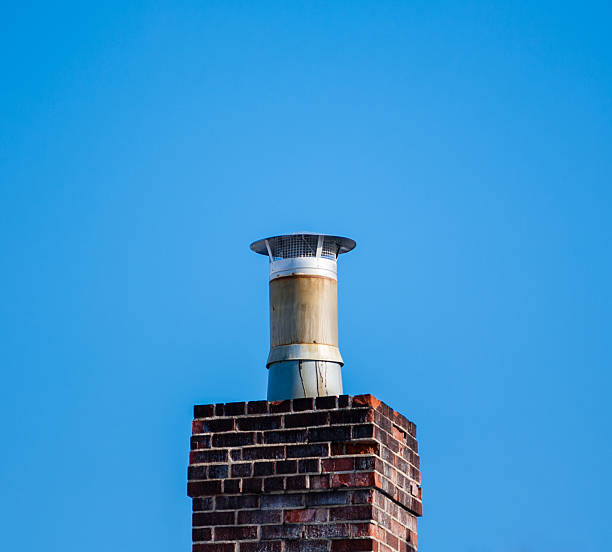 istock Dark brick chimney and filter on blue sky 504600393