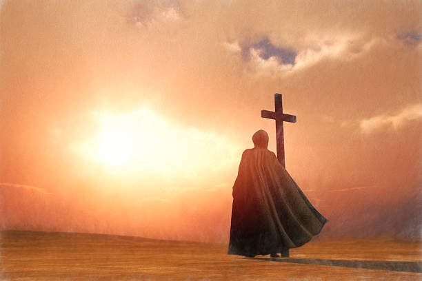 Jesus with cross walking in the desert.