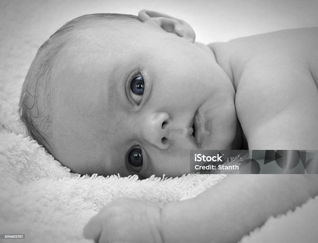 Little baby girl with blue eyes Largely black and white photo of a baby girl looking into the camera with blue eyes. Shallow depth of field 0-1 Months Stock Photo