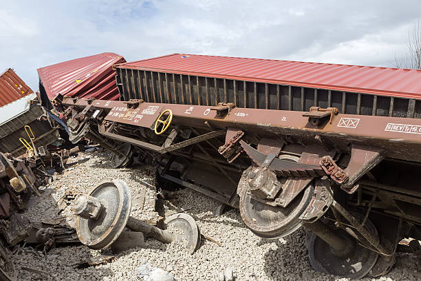 Derailed train coaches at the site of a train accident Thessaloniki, Greece - March 27, 2015: Derailed train coaches at the site of a train accident at the Gefyra community, in northern Greece. The train was carrying electronic equipment . derail stock pictures, royalty-free photos & images