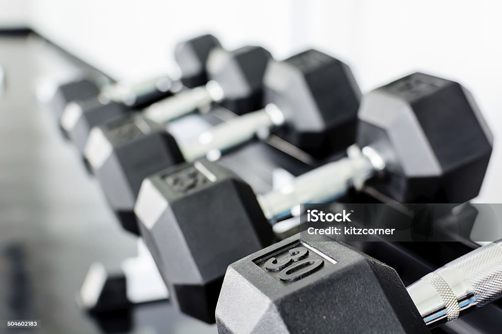 rows of dumbbells on a rack in a gym Dumbbell Stock Photo