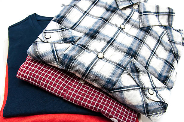 istock Stack of Shirts and T Shirts in different colors isolated 504602467