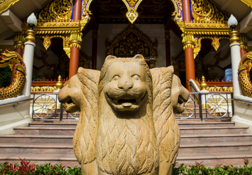 three lion statue in front of asian church