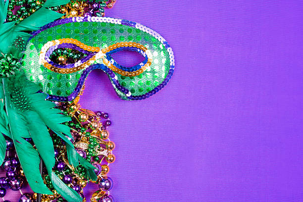 istock Mardi Gras background.  Purple, gold, green, mask, beads. 504602970