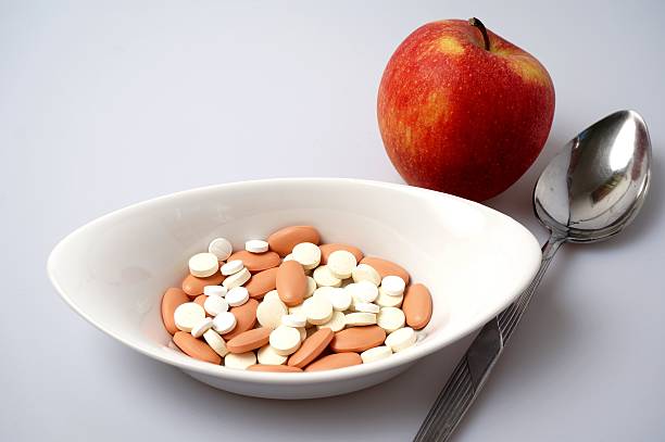 istock Medicine pills vs healthy apple 504603103