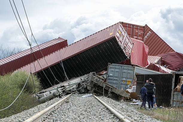 Derailed train coaches at the site of a train accident Thessaloniki, Greece - March 28, 2015: Derailed train coaches at the site of a train accident at the Gefyra community, in northern Greece. The train was carrying electronic equipment . derail stock pictures, royalty-free photos & images