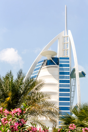 Dubai, United Arab Emirates - March 27, 2014:  External view of the Burj Al Arab in Dubai from the Jumeirah beach.  Burj Al Arab is one of the Dubai Landmark, and one of the world's famous and luxurious hotel in the world.